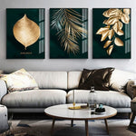 Load image into Gallery viewer, Three contemporary gold and turquoise leaf wall art prints hanging above a sofa
