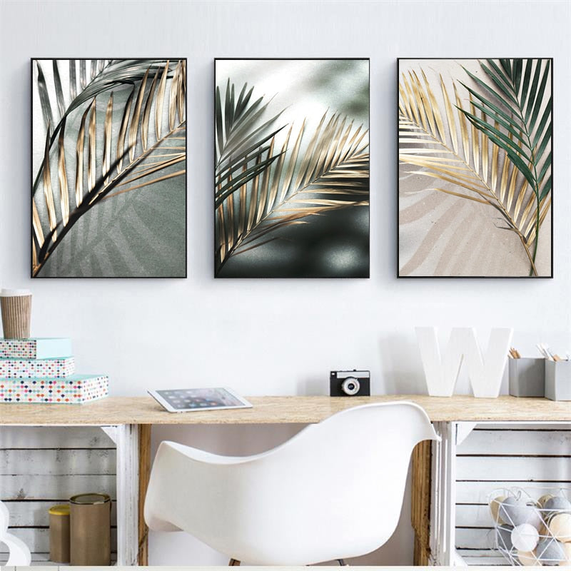 Three nordic golden palm leaf wall art prints hanging above a desk and chair
