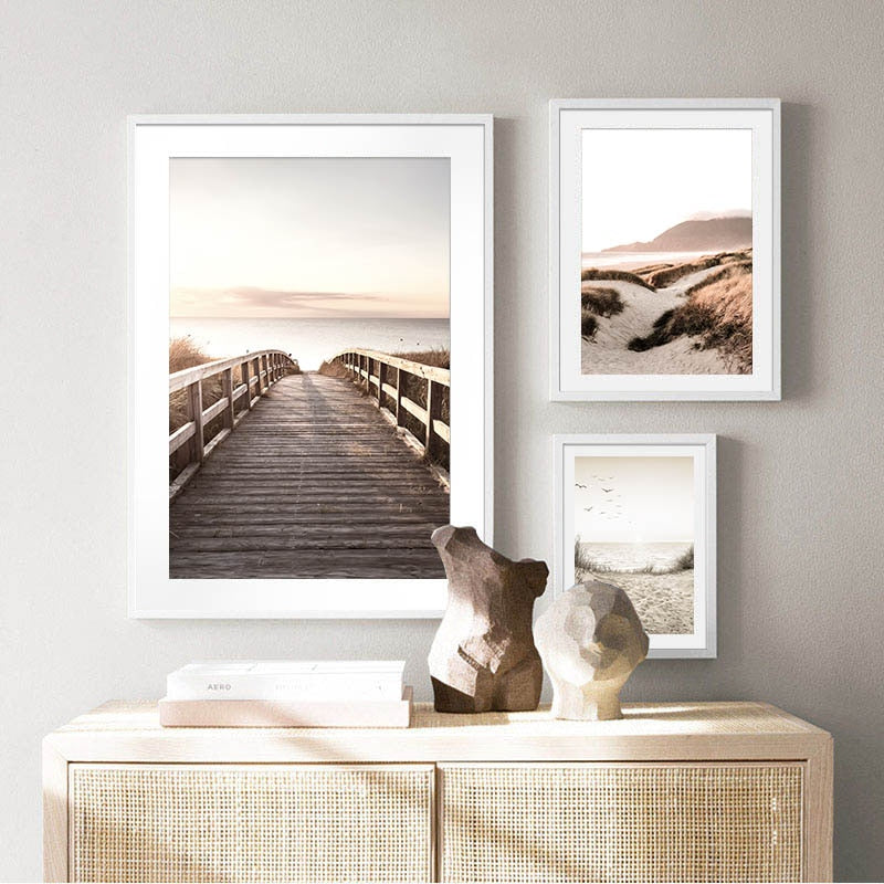 Three scandinavian beach nature landscape wall art prints hanging above a table