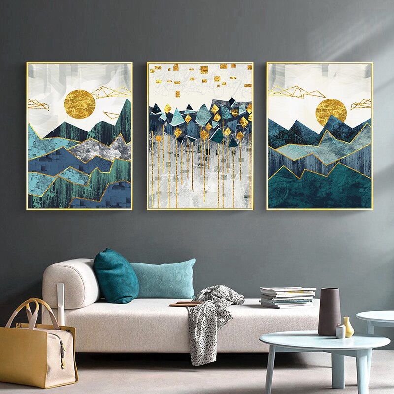 Three golden sunrise mountain rain drop wall art prints hanging above a sofa