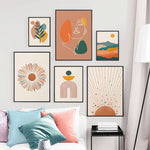 Load image into Gallery viewer, Gallery wall of six pictures made up of a white line drawing of a female face a colourful mountain range with an orange sun and a green leaf frond sun rise wall art prints
