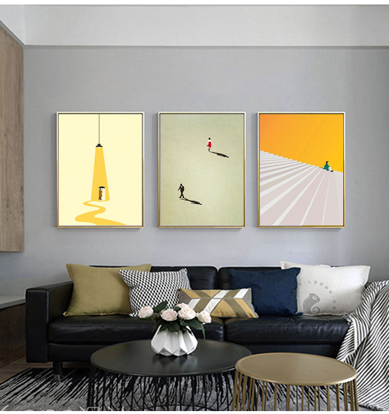 Three contemporary nordic wall art prints hanging above a sofa